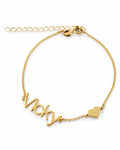 Gold-finish Fidji Love personalised bracelet with “Vicky” lettering, a small heart and an extension chain on a white background.