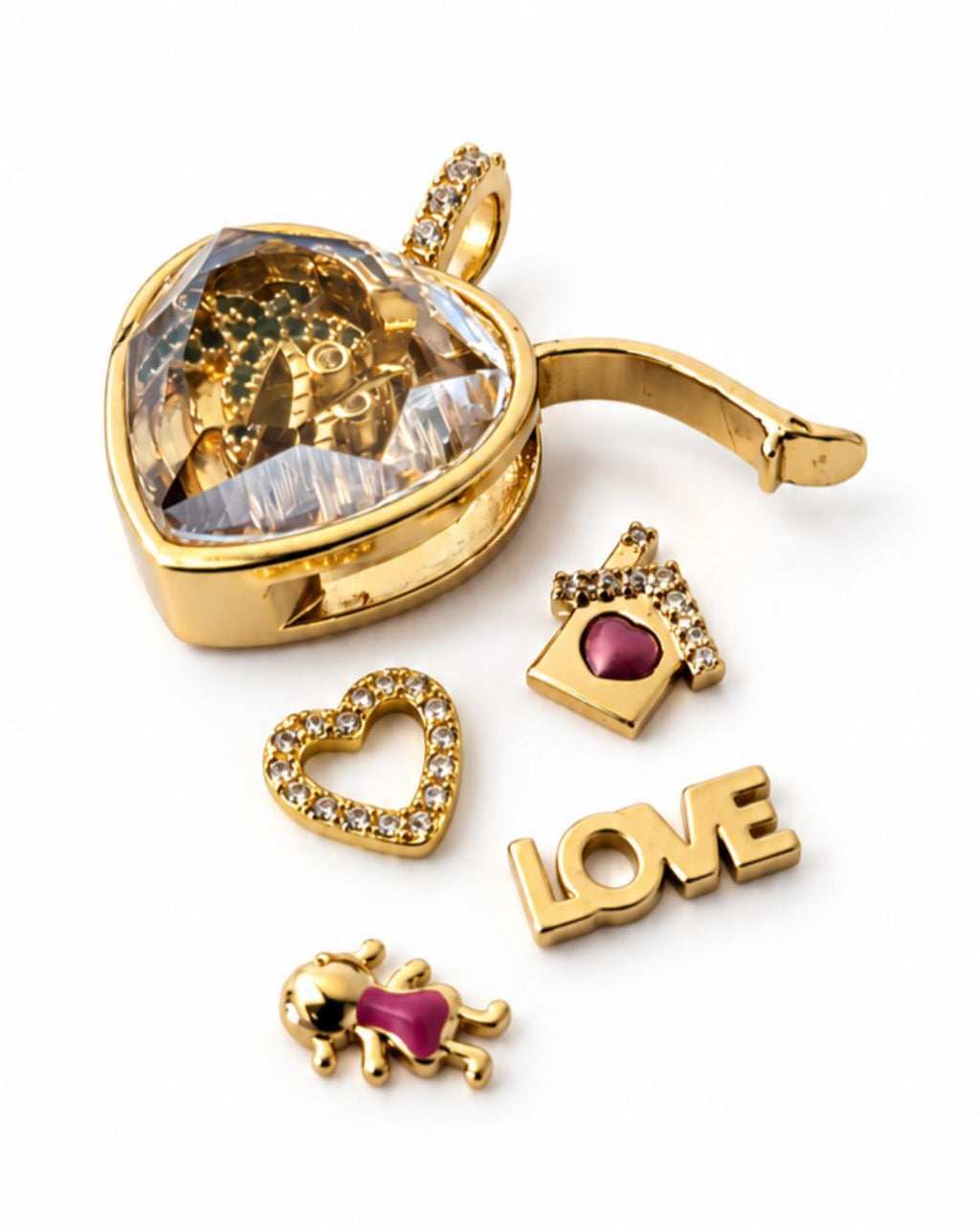 Open gold heart locket with decorative charms, including a heart, camera and LOVE lettering, on a white background