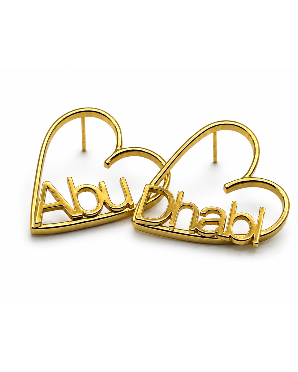 Gold-finish Love Story personalised heart earrings with “Abu” and “Dhabi” lettering on a white background.