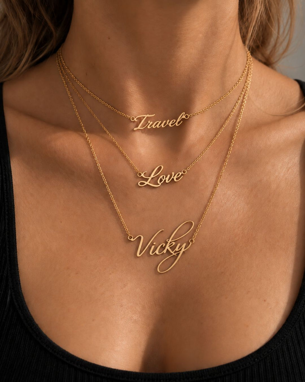 Woman wearing layered MIAMI personalized necklaces with cursive word pendants