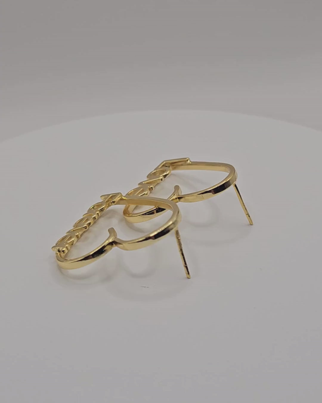 Love Story personalised heart earrings in a gold finish, featuring “Love” and “Forever” lettering.