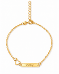Gold-tone Venice personalized bracelet with an open heart, a bar engraved “Vicky” and an adjustable chain, shown on a white background